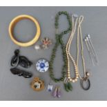 A collection of jewellery including jadeite necklace, ivory bangle, jet earrings, jet brooch,