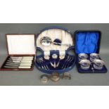 Three hallmarked silver napkin rings, four cased glass salts with spoons,