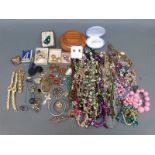 A collection of costume jewellery including beads, brooches,