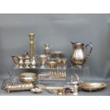 A quantity of silver plate to include large jug, sauce boats, toast racks, salt and pepper shakers,