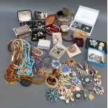 A collection of jewellery including beads, marcasite brooches, Hollywood brooch, bangles,