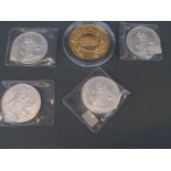 Four uncased Bahamas 1972 five dollar coins together with an English Sadler's Wells medallion