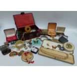 A collection of costume jewellery including brooches, beaded necklaces,