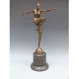 An Art Deco style bronze figure of a female dancer in 1920's attire, raised on a marble base,