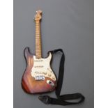 Fender Stratocaster, serial number F204657, with shoulder straps and some spare accessories,