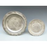 A pewter platter with touch marks and I I M to underside together with a smaller example with