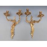 A pair of brass double candle wall sconces,
