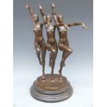 A bronze Art Deco style figure of three nude synchronised dancers on circular base,