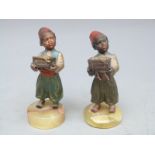 A pair of Austrian cold painted bronze figures of African children bearing caskets of jewels,