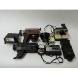 A quantity of cameras and accessories including Polaroid, Topcor 80m 1:4 lens,