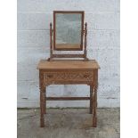 Limed oak mirror back dressing table with carved decoration,