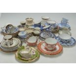 A collection of tea cups and saucers and coffee cans including Crown Derby and Spode examples