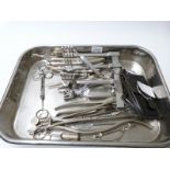 A stainless steel tray of surgical instruments, mainly early 20thC,