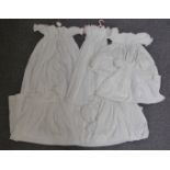 Collection of vintage christening gowns including broderie anglaise and lace trimmed