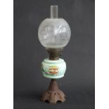 A 19thC oil lamp with painted glass