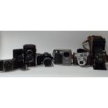 A quantity of cameras to including Fuji Finepix S5600 and S304, Halma Flex TLR, Kodak Retinette 1A,