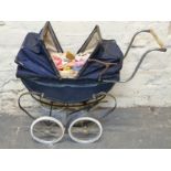 A vintage double ended pram in navy with two hoods together with Barbie dolls and clothing
