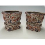 A pair of Oriental jardinieres with stands,