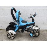 A child's pale blue and black tricycle