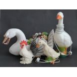 Large swan ornament with faux fruit display, together with several bird lamps,