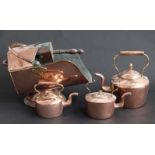 A collection of copperware to include coal scuttle with shovel and three various sized kettles