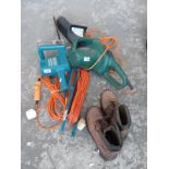 An electric chainsaw together with a Black and Decker hedge trimmer, extension lead,
