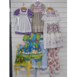 Eight dolls / children's dresses or part outfits some with lace decoration and printed patterns