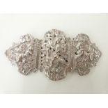 Indian or Eastern white metal belt buckle decorated with embossed figures,