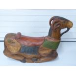 A carved and painted wooden rocking ram or goat,