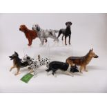 Seven Royal Doulton dog figures including English Setter, German Shepherd,