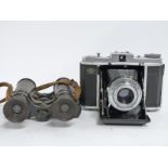 Zeiss Ikon Nettar folding camera together with an early 20thC pair of prismatic binoculars