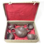 A cased Chinese Yixing tea set depicting dragons, marked to inner lid,