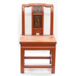 A Chinese chair with figural panel and painted in red,