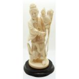 A late 19th/early 20thC Chinese ivory figure of a man with a cockerel and a dog,