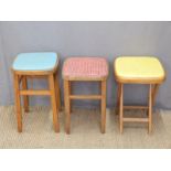 Three retro kitchen stools and two rush seated examples