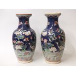 A pair of Chinese vases decorated with bird, insects and flowers with seal mark to base,