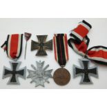 German WWII medals comprising three Iron Crosses, a War Merit Medal with ribbon,