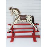 Lines Bros wooden dapple grey rocking horse on red base stamped LB Ltd SP1, 115cm long,