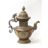 A 19thC Tibetan copper and brass ceremonial teapot and cover with zoomorphic dragon handle and two