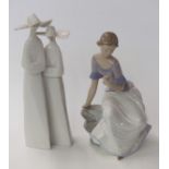 Lladro figural group of two nuns and a Nao figurine of a girl with flowers