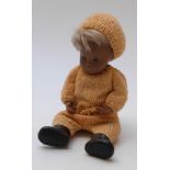 Sasha doll with brown lips, blue eyeshadow, brown hair, black shoes and knitted orange outfit,