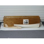 A large colection of wooden aeroplane and boat model kit parts in a wooden chest with rope handles