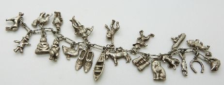 A silver charm bracelet set with 20 charms including duck, monkey, donkey, horse, cat,