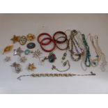 A collection of jewellery to include pearl necklace, turquoise necklace, Grosse brooch,