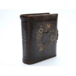 Musical 'Reuge' Carte Visite album with embossed leather cover and brass clasp