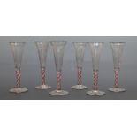 A set of six 19thC engraved wine glasses with latticino swirl stems