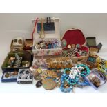 A large collection of costume jewellery including brooches, beads,