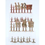 An 18thC German figural bone chess set with turned and carved pieces, one side stained red,