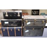 Five vintage travelling trunks including a large ash bound steamer trunk,