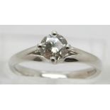 An 18ct white gold ring set with a round brilliant cut diamond solitaire of approximately 0.